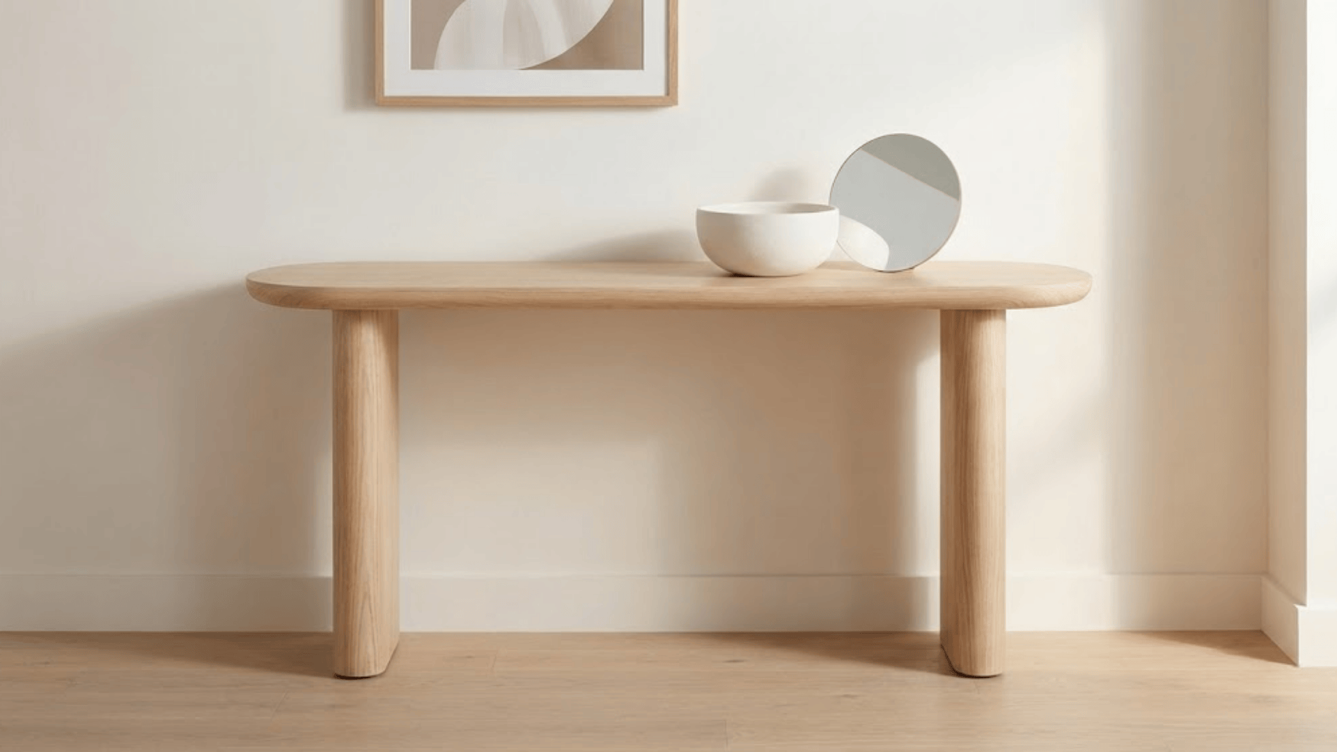 curved edge console table in light ash wood with rounded legs and soft organic lines against white wall