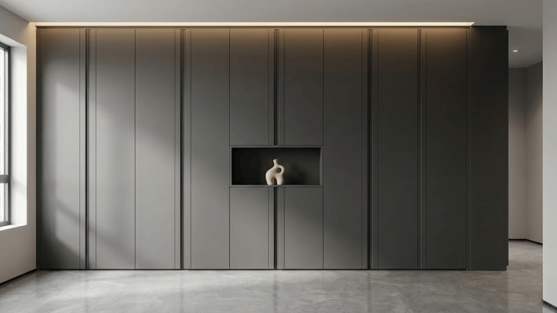 seamless gray handleless cabinetry with push-to-open doors and integrated shelf in modern entryway