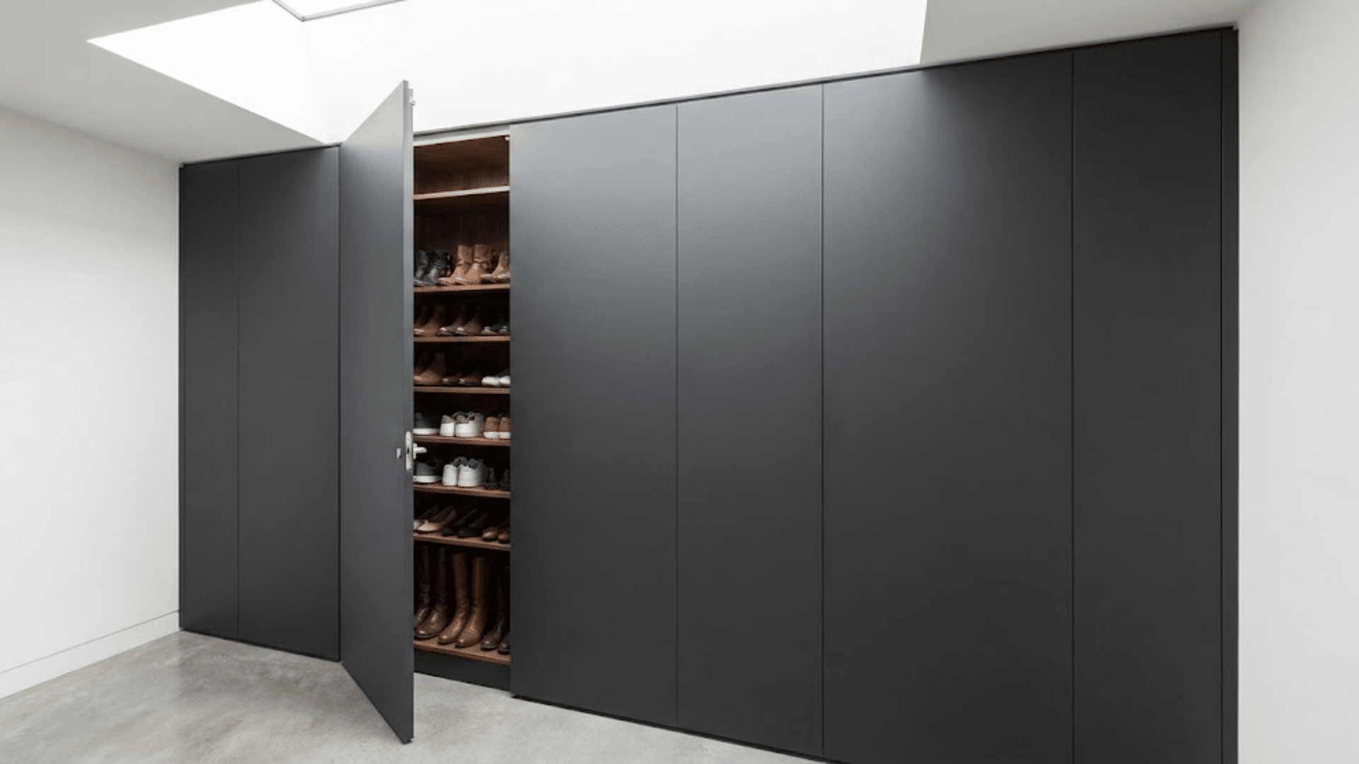 matte gray wall panels with one open showing hidden shoe storage cabinet and interior shelving (1)