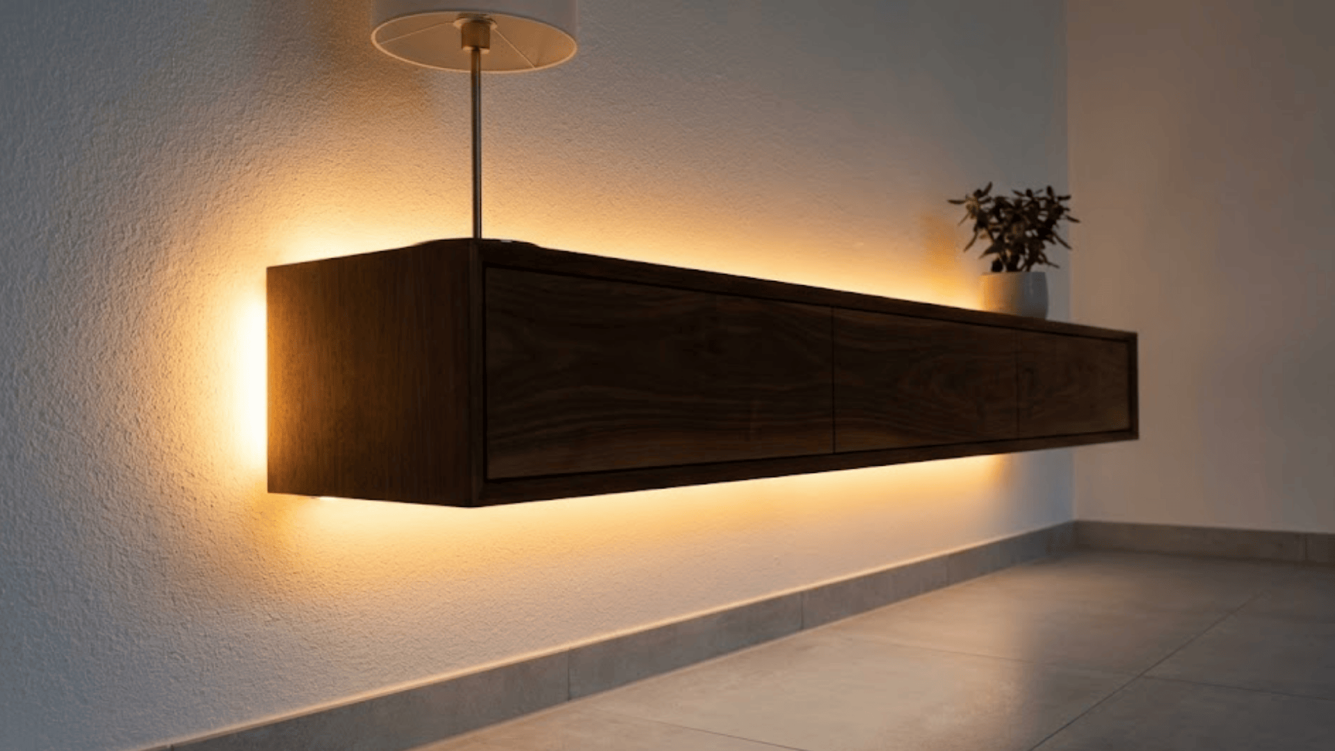 floating walnut console with hidden led strip underneath creating warm glow on wall and floor