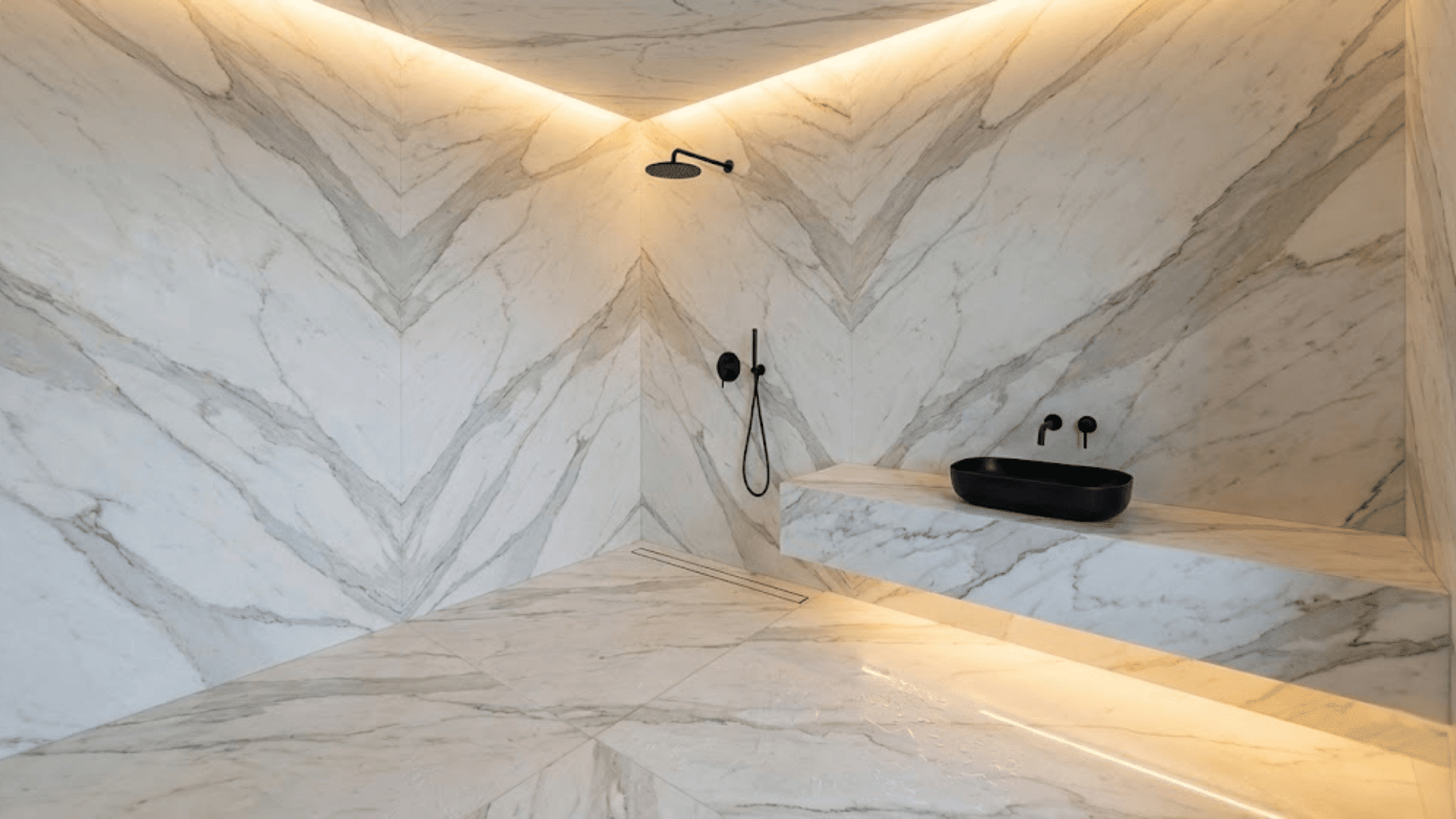 high-end doorless shower with seamless book-matched marble transitions and integrated linear drain