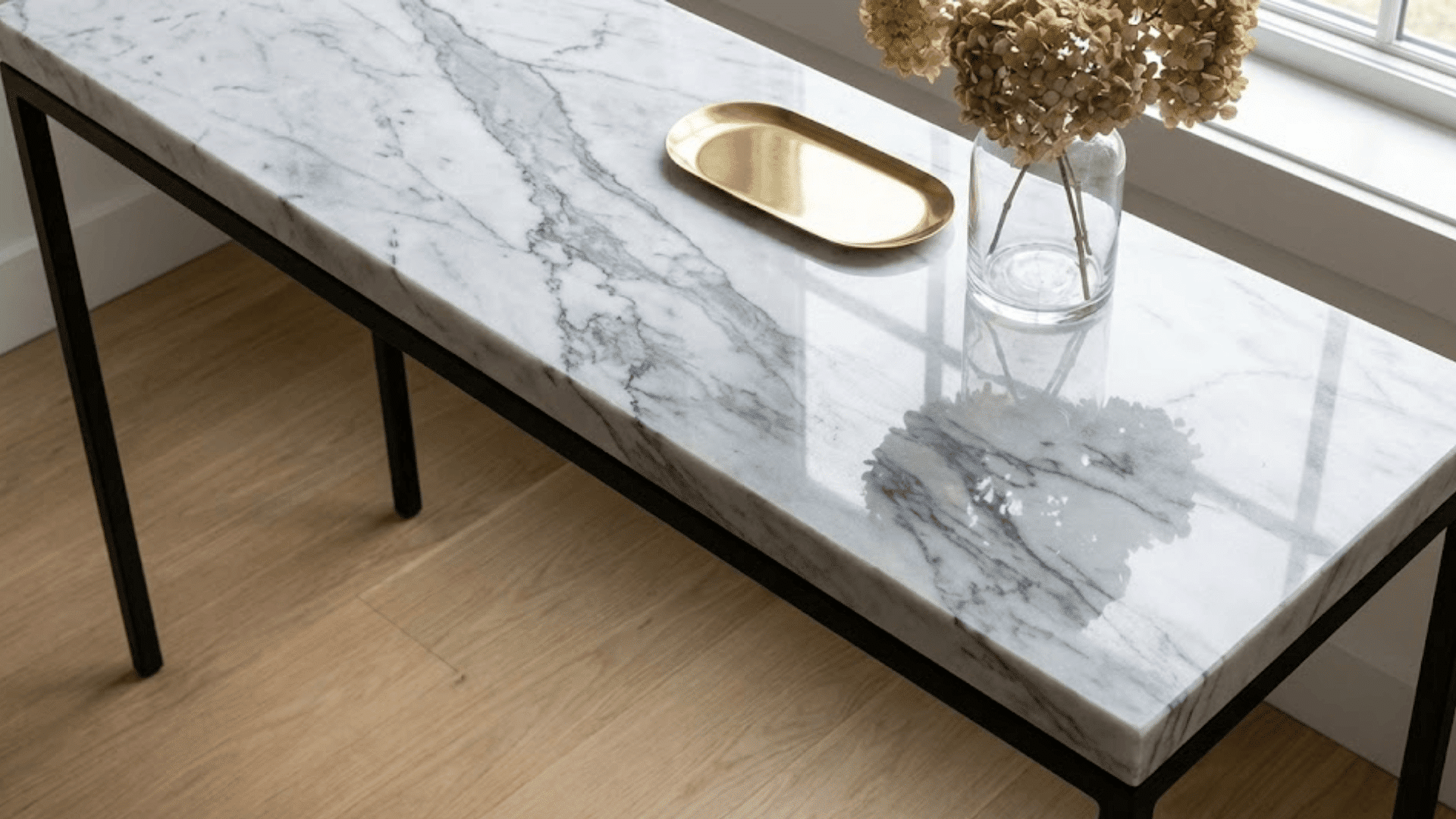 white carrara marble console top with gray veining and polished surface reflecting light naturally