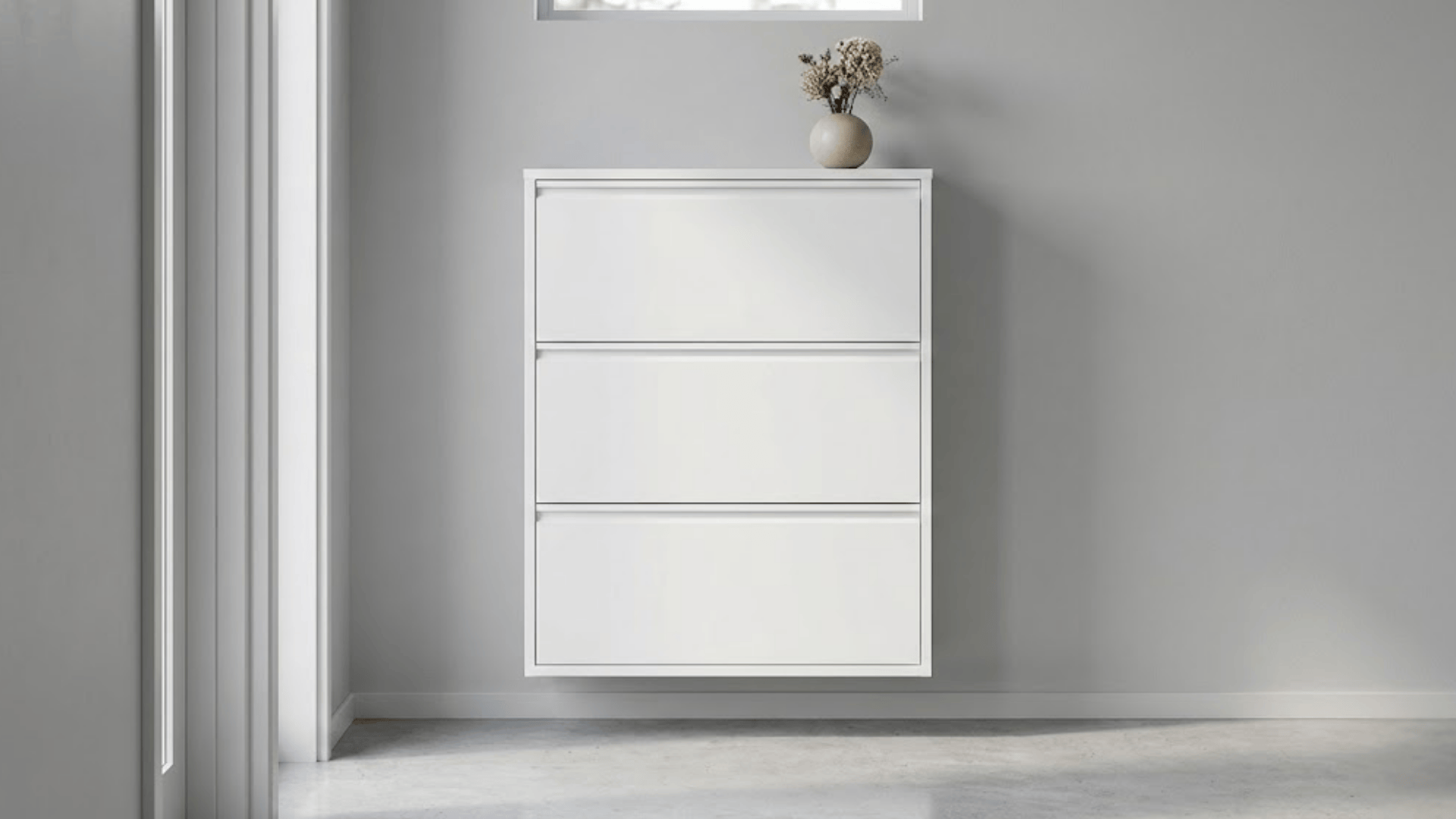 slim white shoe cabinet with seamless push-to-open doors and minimal profile against gray wall