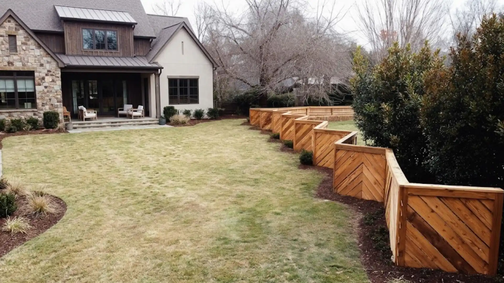 zig zag wooden fence layout creating angled privacy sections in a landscaped backyard