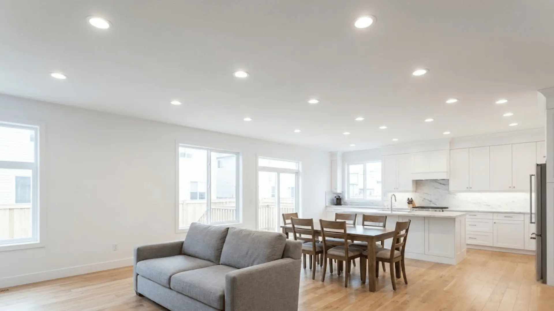 evenly spaced recessed lighting providing ambient coverage in open floor plan