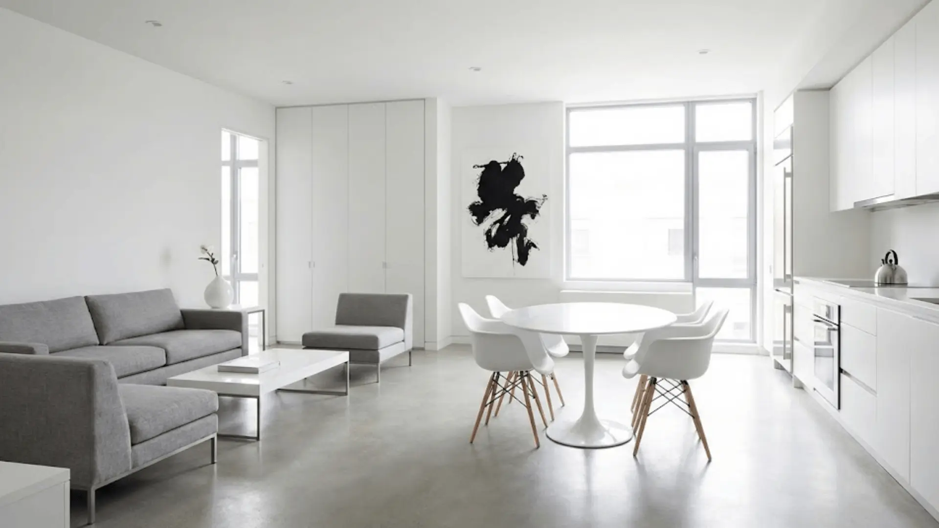 modern minimalist open floor plan with white and gray monochromatic palette