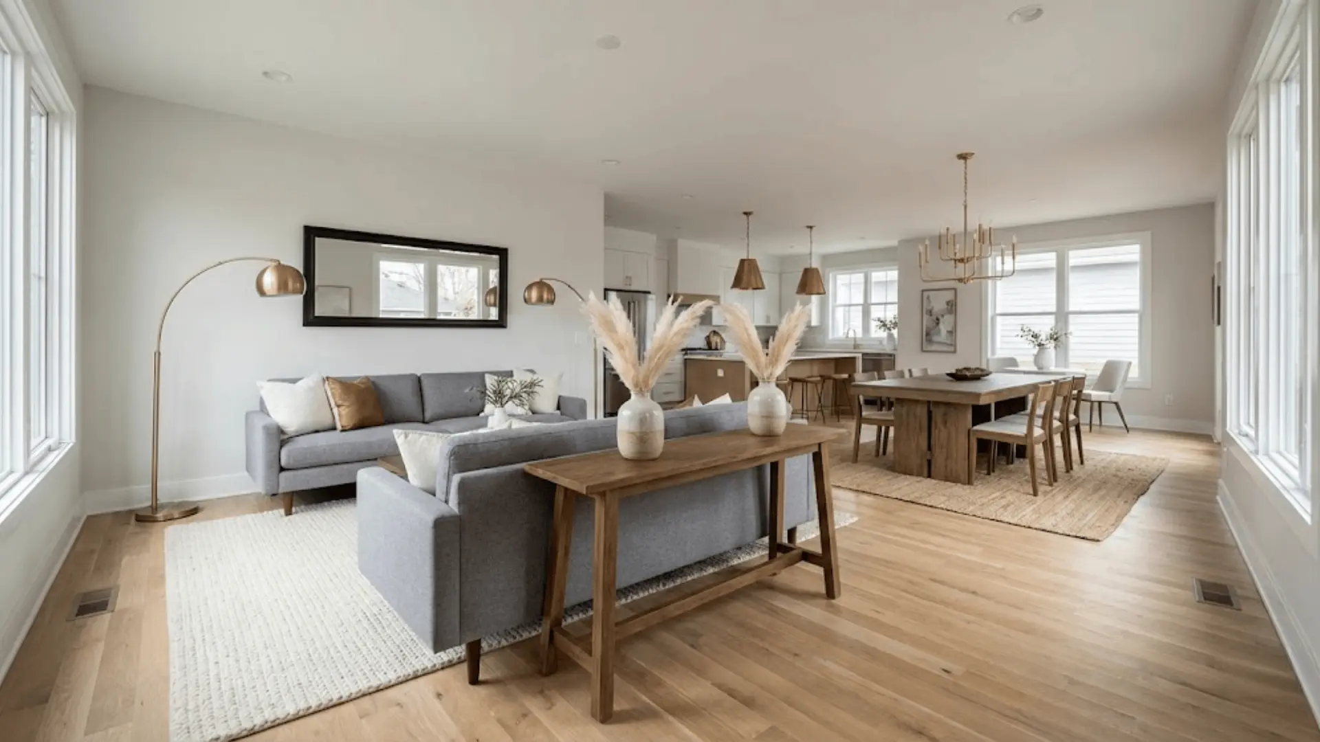 symmetrical furniture and lighting across living and dining zones in open floor plan