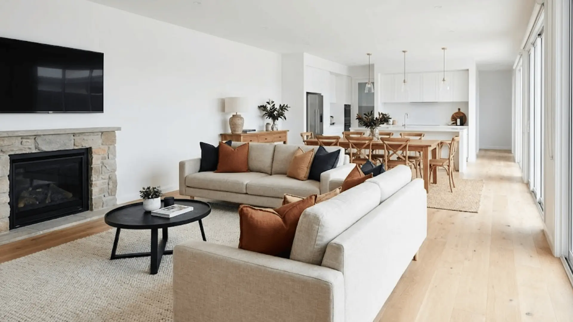 two sofas placed back-to-back dividing living and dining areas in open floor plan