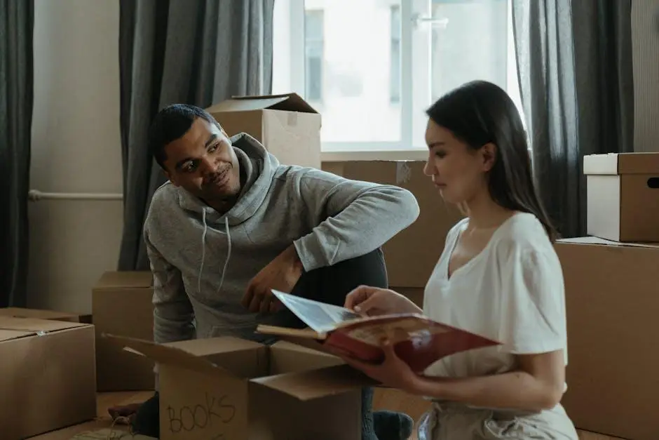 Couple unpacking boxes in living room with sunlight through window