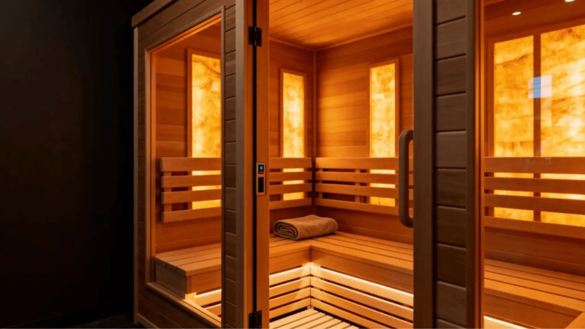 Wooden infrared sauna interior with glowing panels and bench under warm lighting