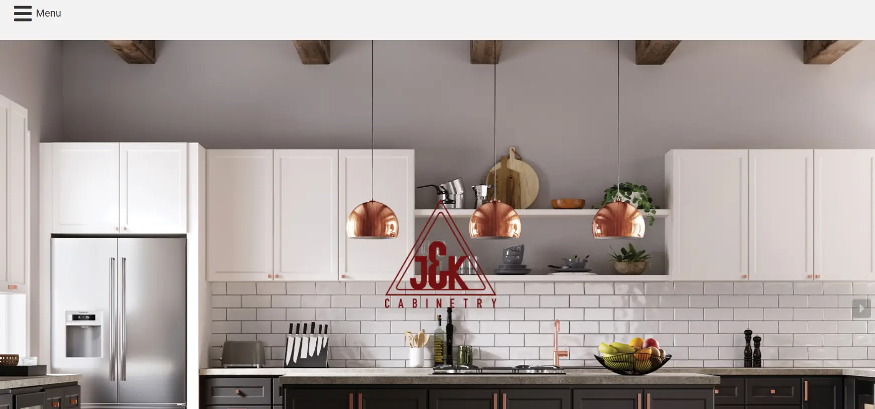 Modern kitchen with white cabinets, stainless steel fridge, copper pendant lights, and fruit bowl on counter