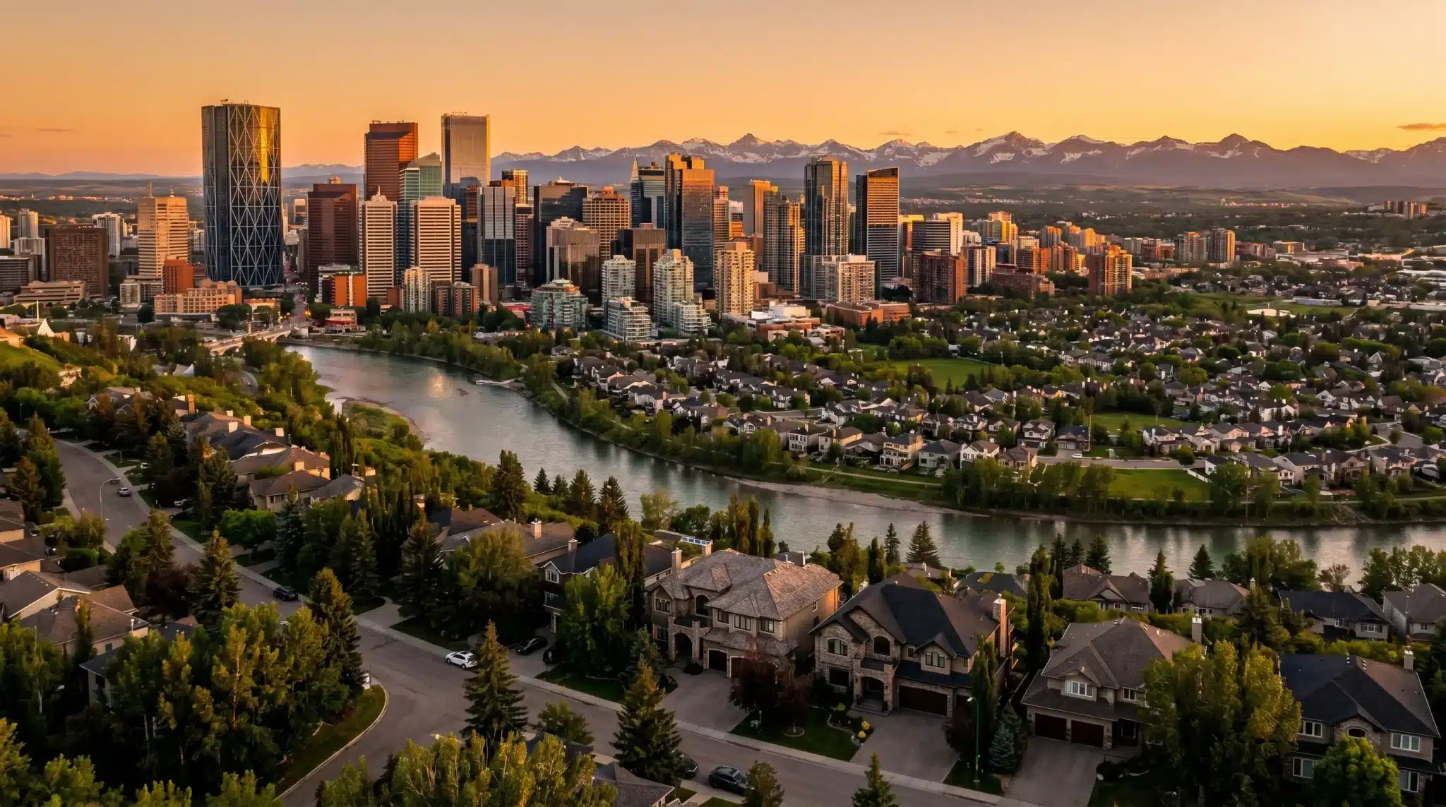 City skyline with skyscrapers at sunset, river, and residential area in foreground