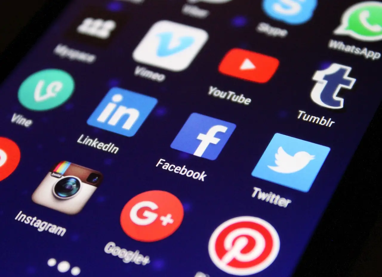 Smartphone screen displaying various social media app icons with a dark background