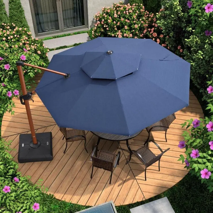 Blue patio umbrella over wooden deck with wicker chairs surrounded by blooming flowers