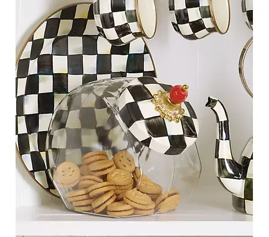 Black and white checkered kitchenware with glass jar of cookies on shelf
