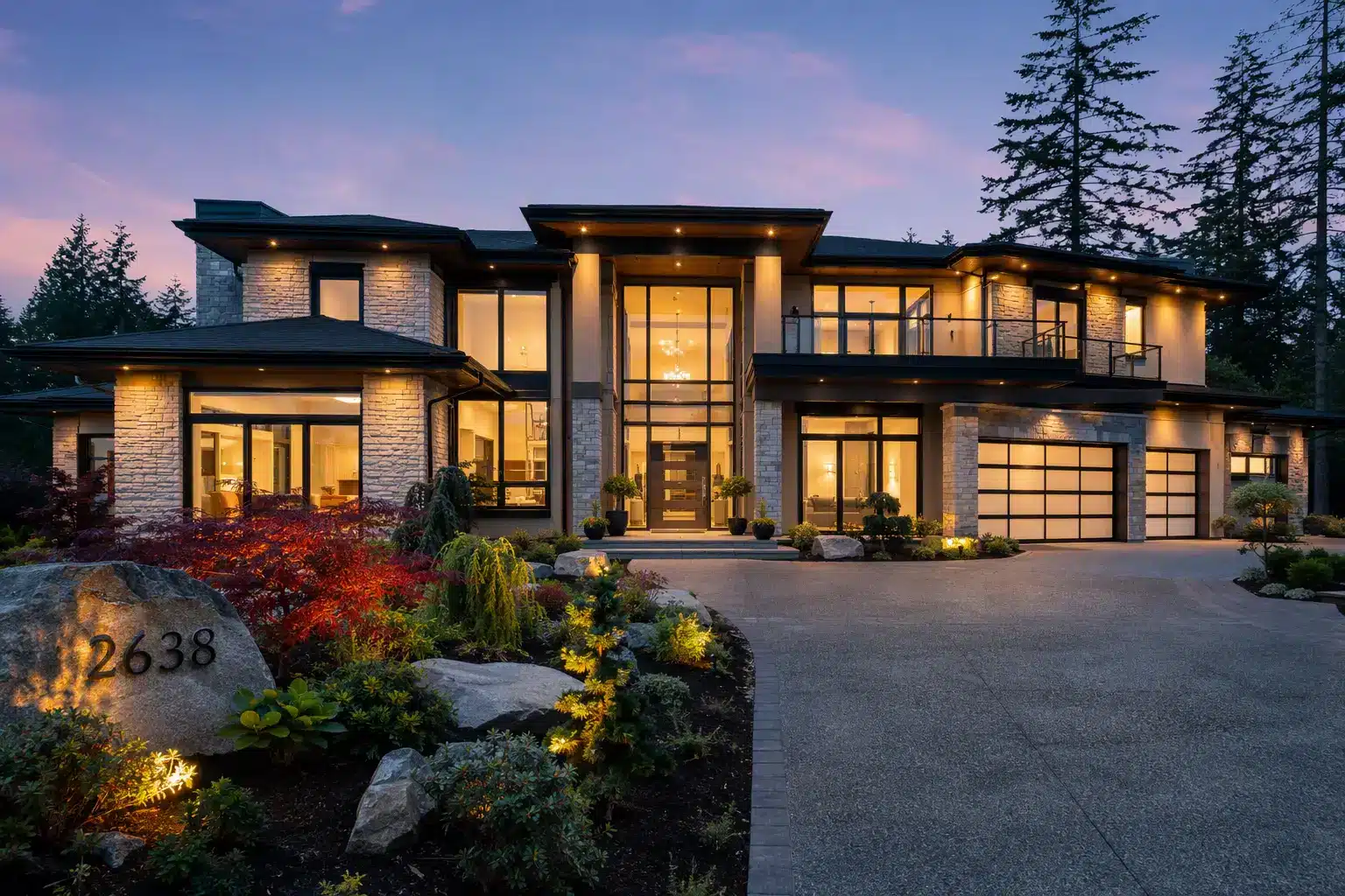 Modern luxury home exterior with large windows and landscaped garden at dusk, warm lighting throughout