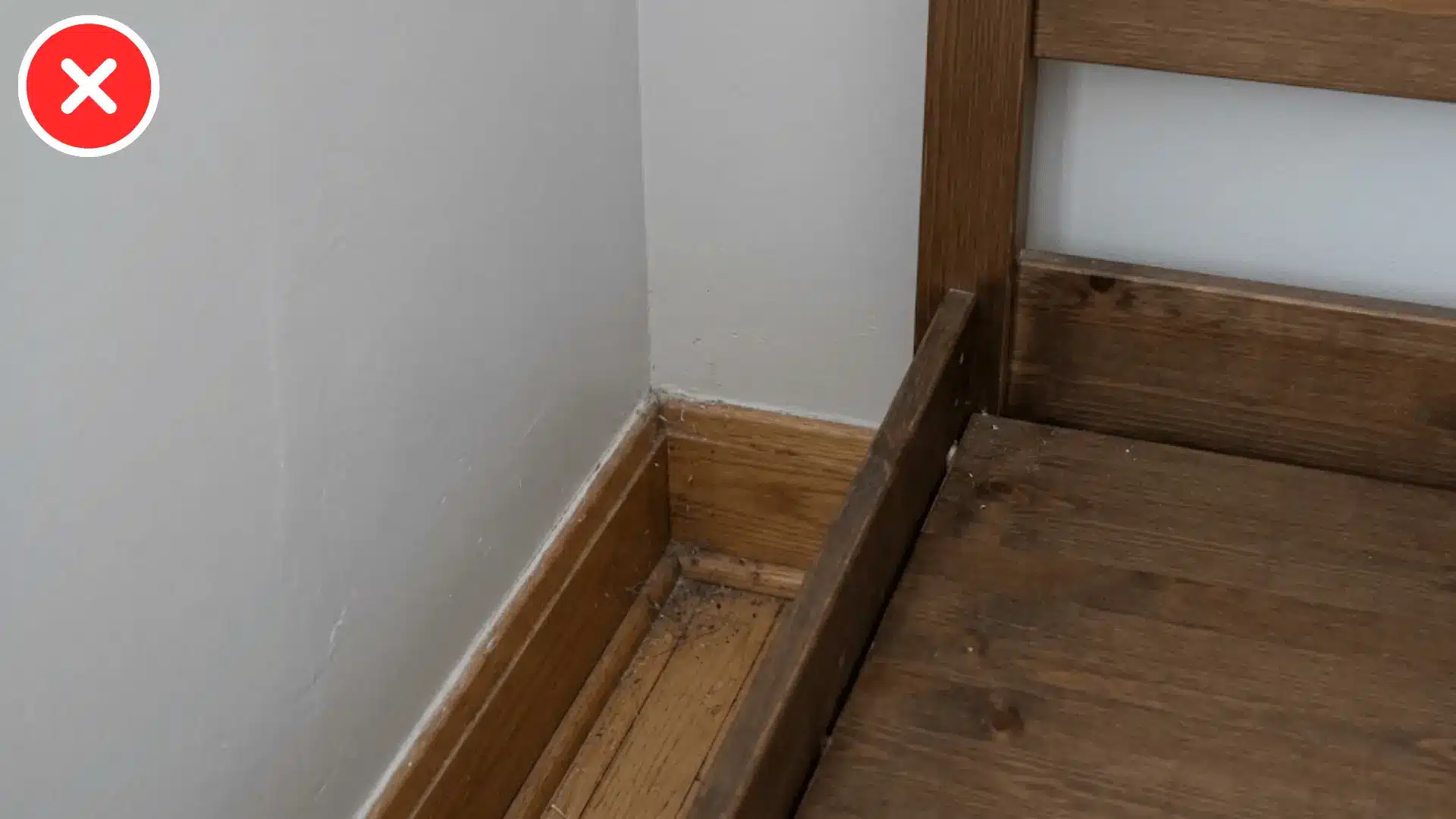 close up of a bed frame wedged into a tight room corner with no side gap