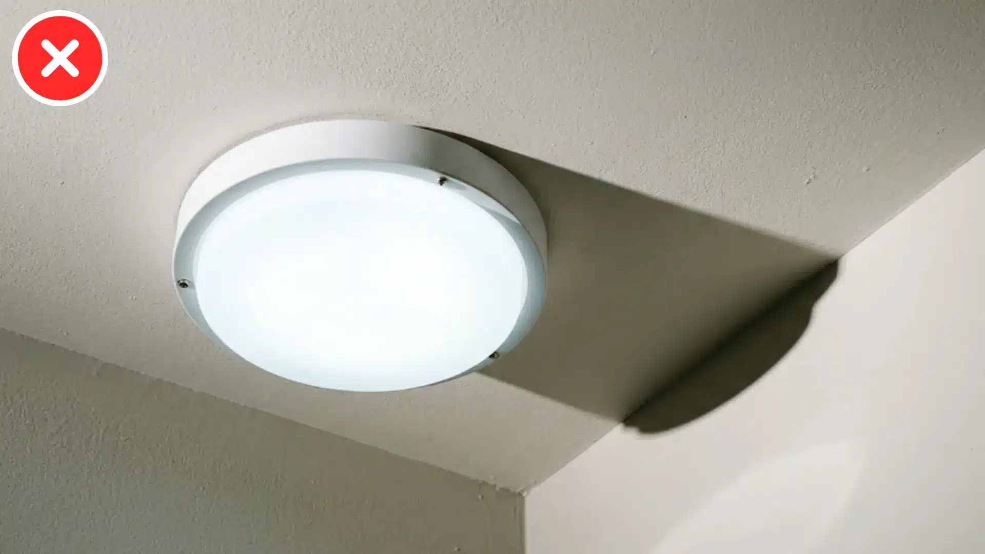 close up of a flush mount ceiling light casting flat cool toned illumination