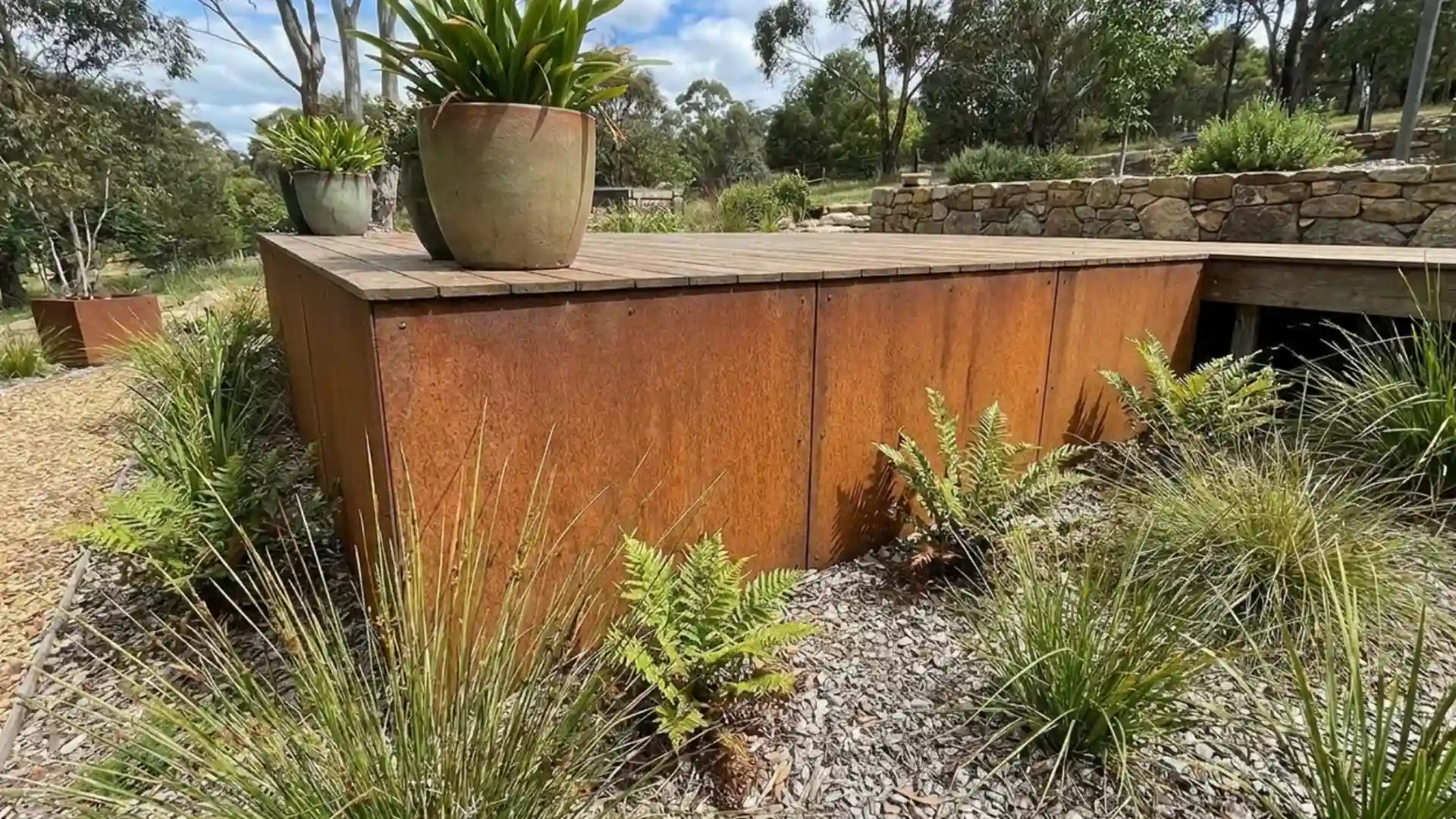 corten steel deck skirting panels with rusted patina in native garden landscape