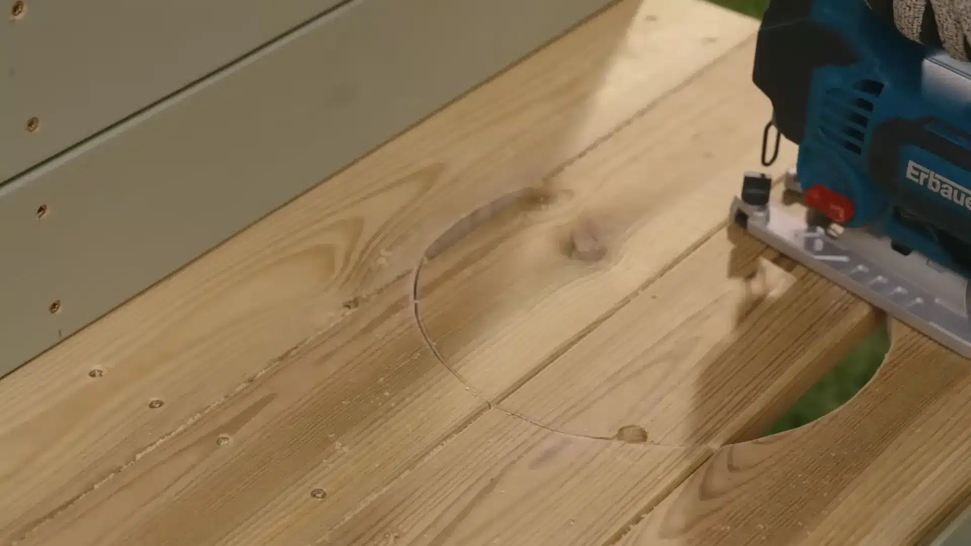 jigsaw cutting circular sink opening into wood countertop for pallet mud kitchen build
