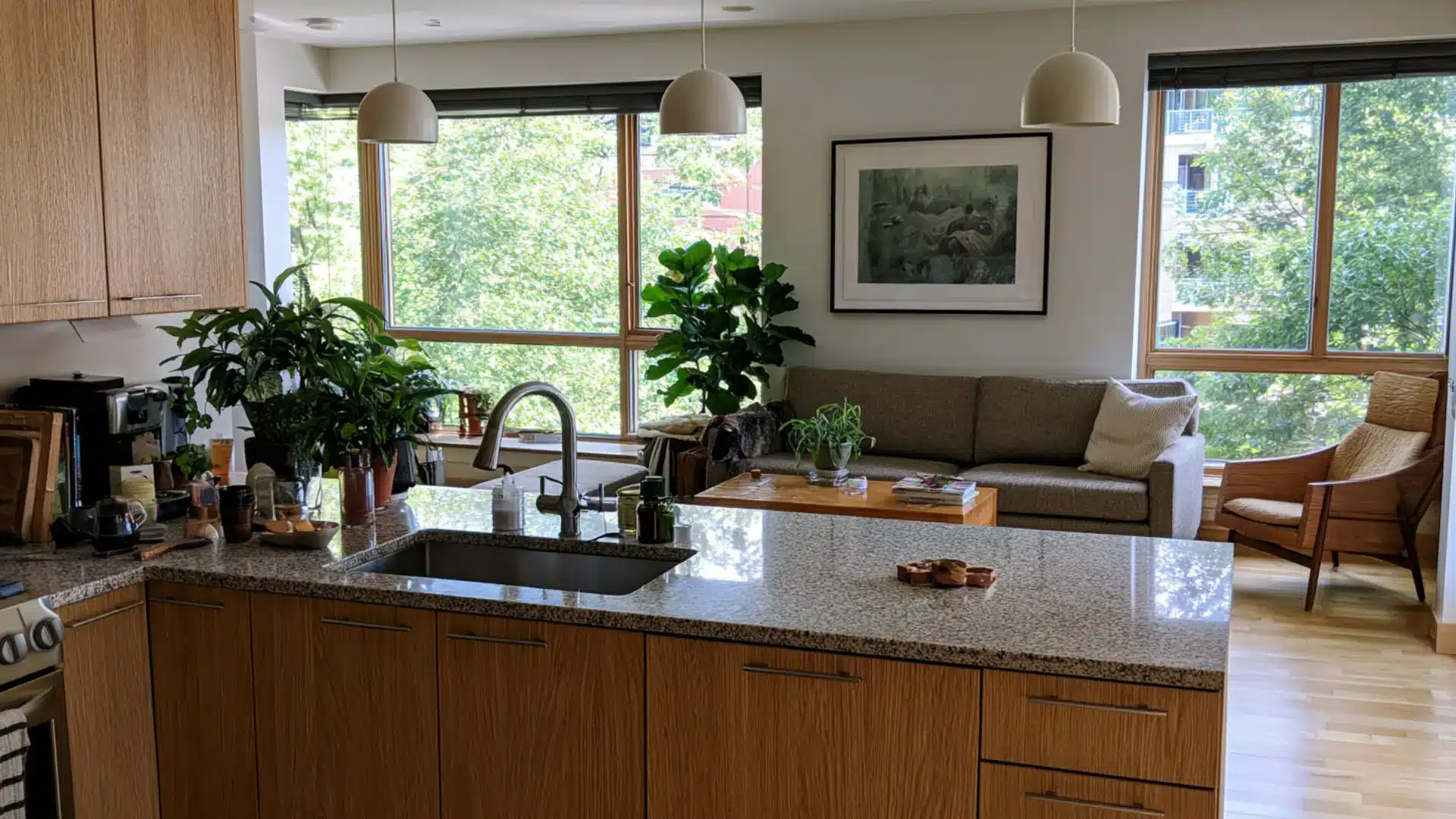 kitchen with wood cabinets matching wood tone furniture in living room beyond