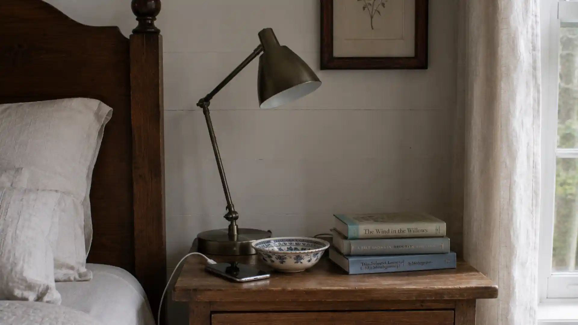 modern reading lamp with charging cable beside vintage nightstand objects