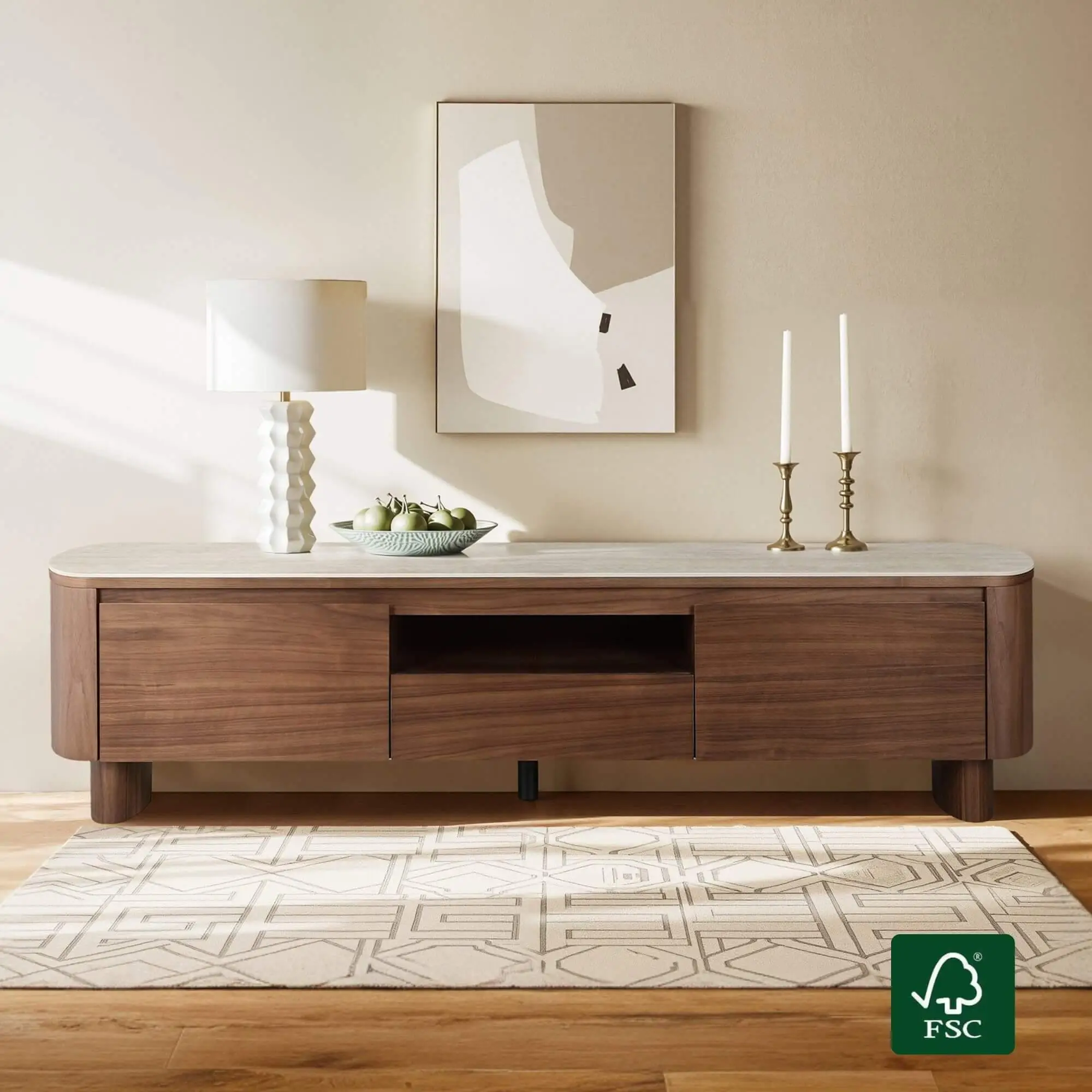 Mid-century modern sideboard with apples, lamp, and candlesticks under abstract wall art in bright room