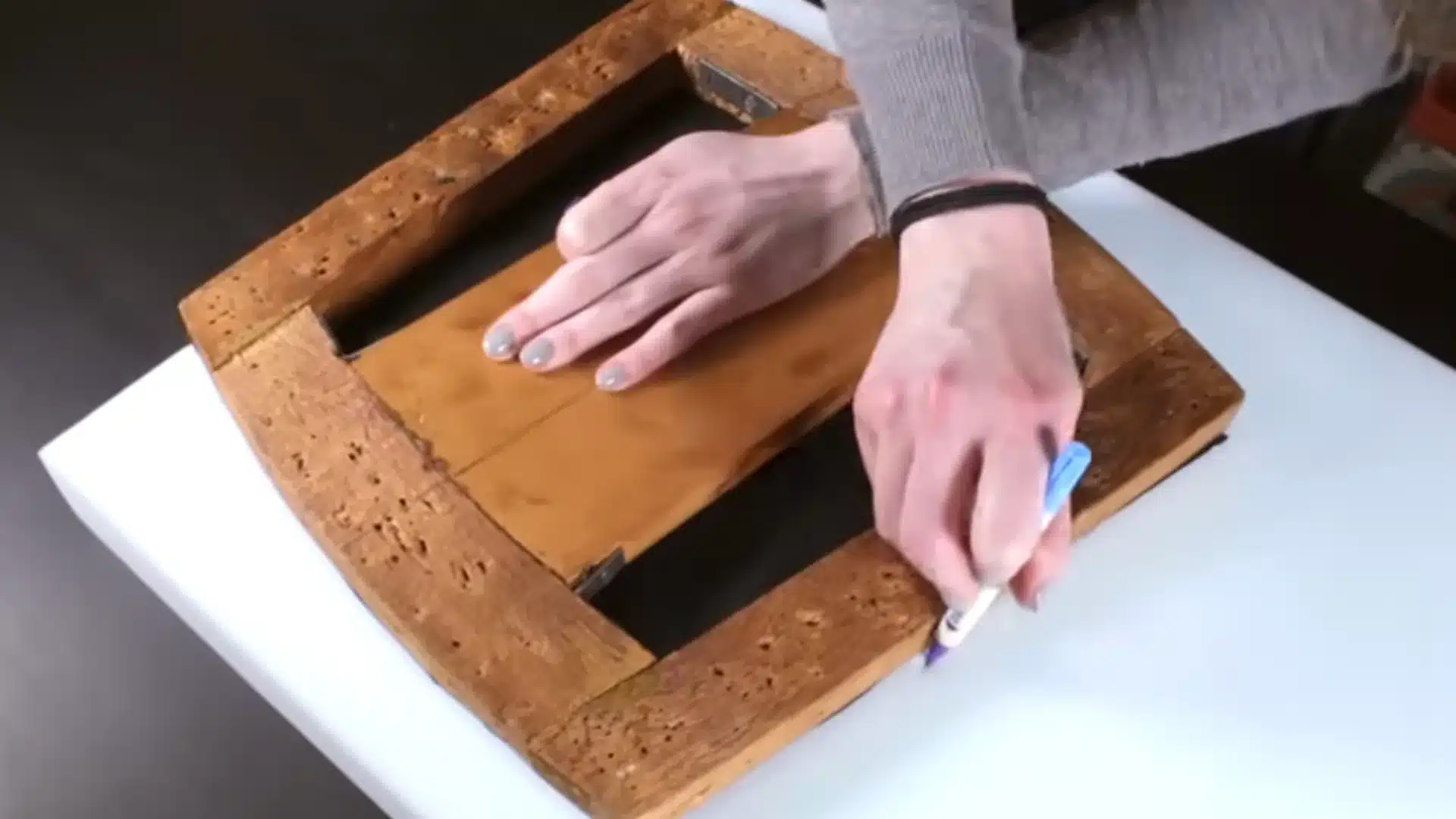 wooden chair seat frame being prepared and marked before adding new foam and upholstery padding