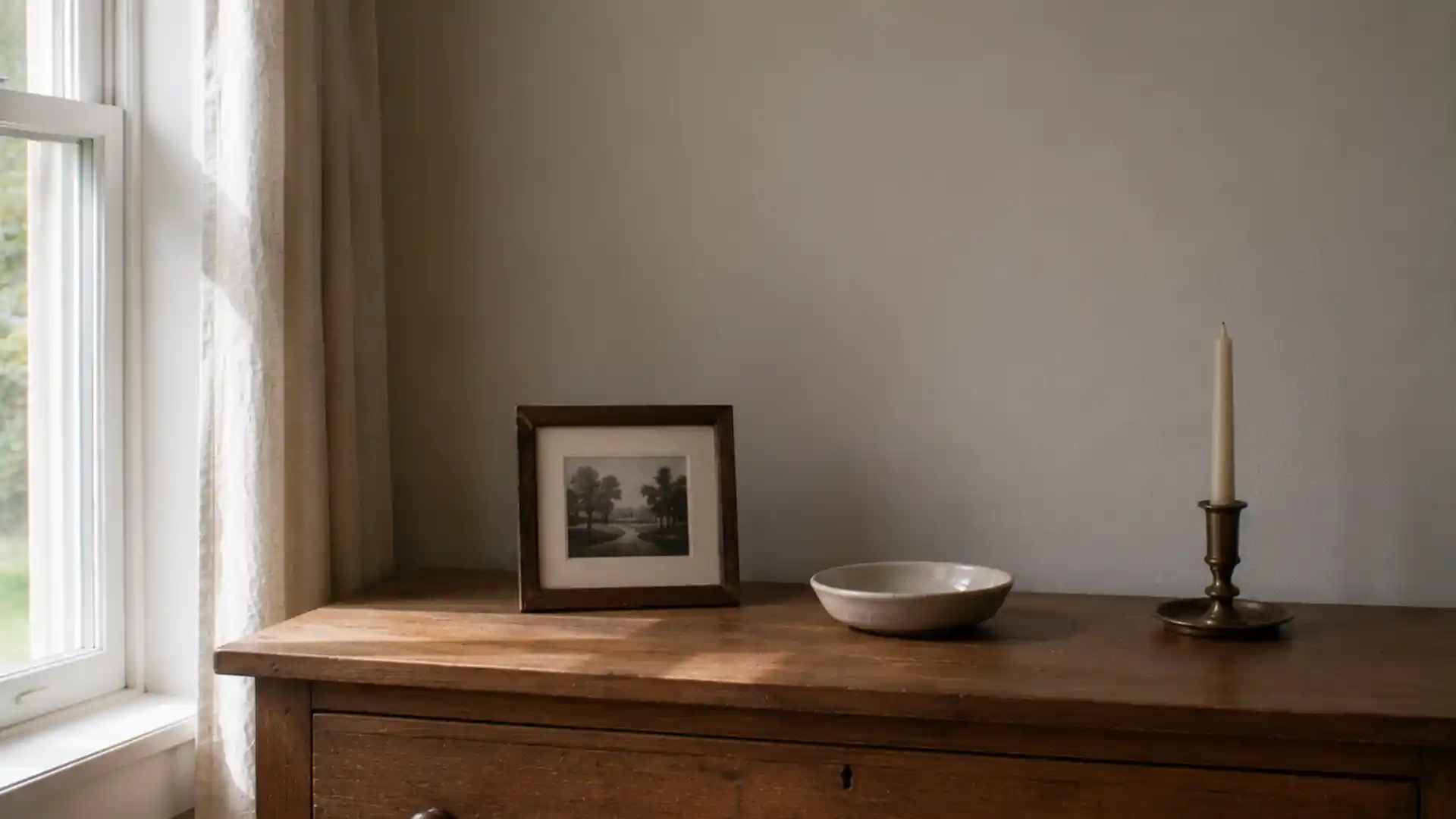 wooden dresser with a few meaningful objects and open empty space
