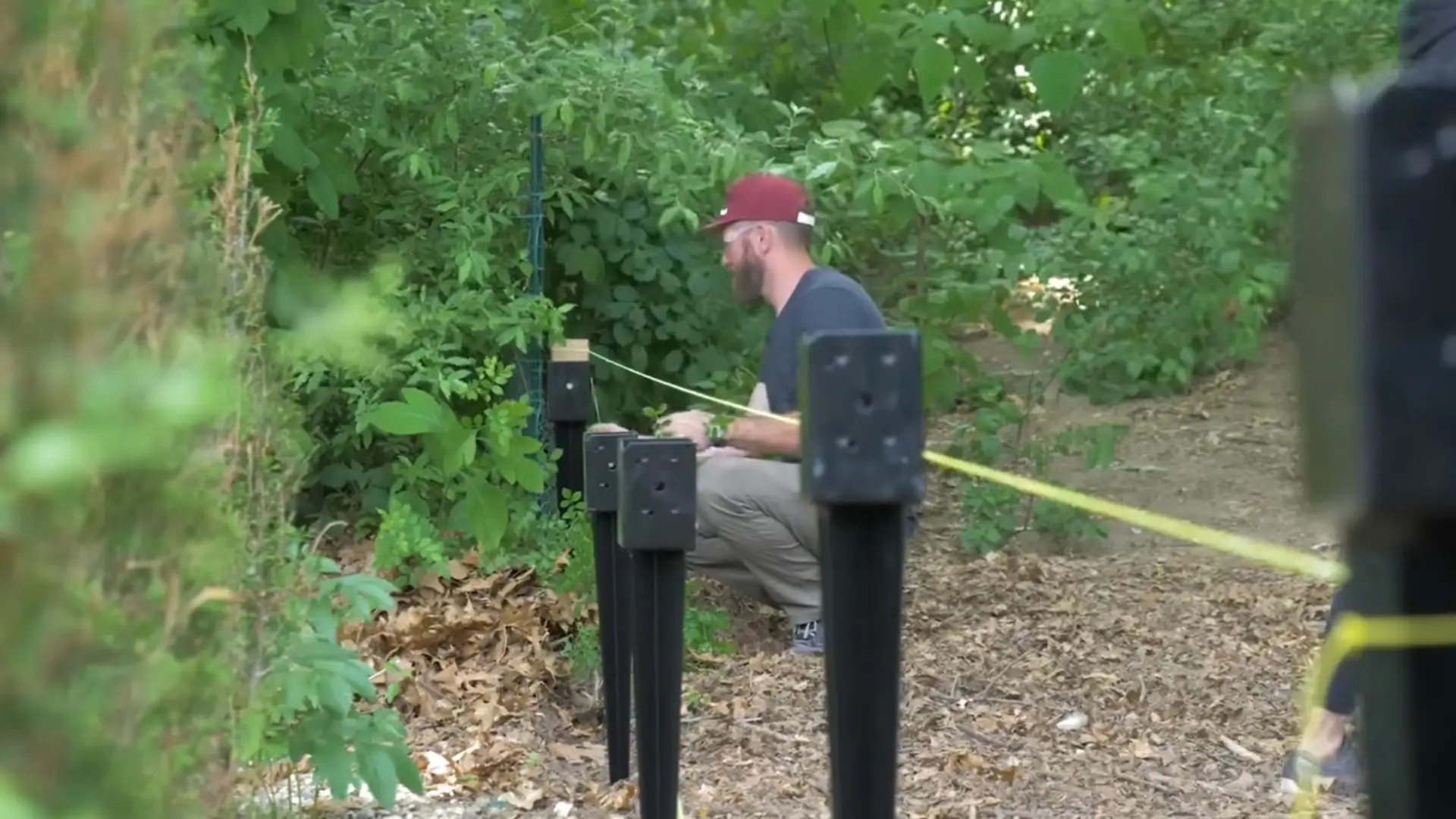 using string lines to align and secure wooden fence posts evenly