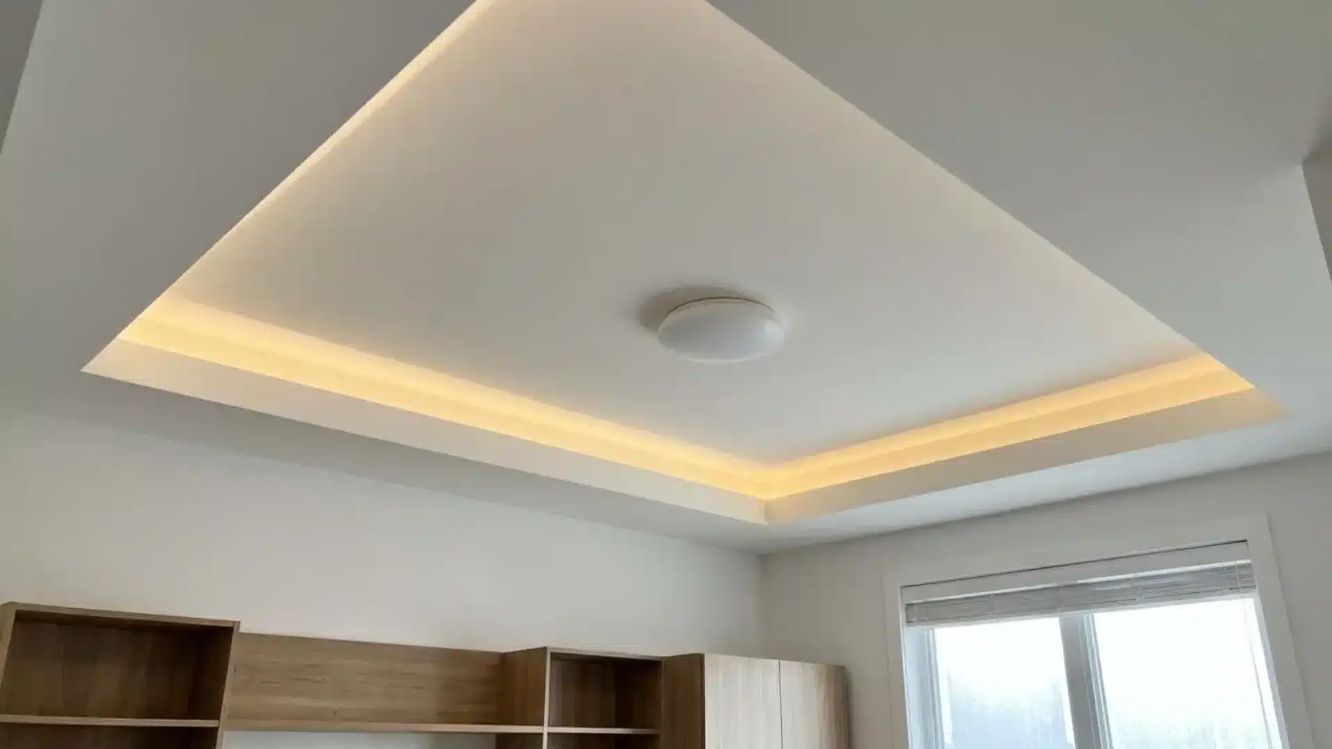 shallow tray ceiling with warm hidden led lighting in a modern living room